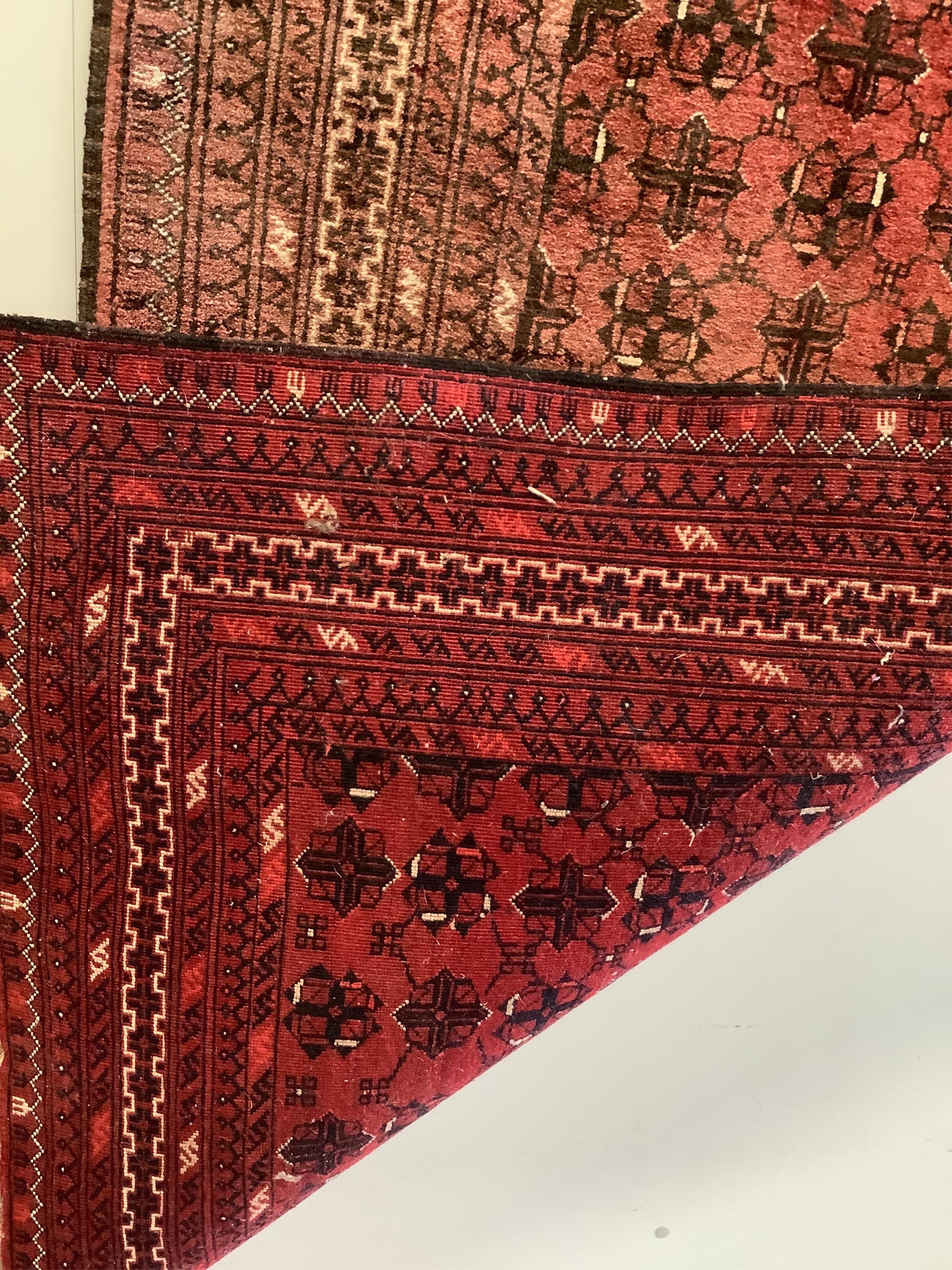 An Afghan red ground rug, 200 x 106cm. Condition - fair